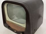 an old fashioned television sitting on a white surface