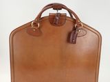 an image of a brown briefcase sitting on top of a white surface