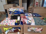 many boxes full of clothes sitting on the floor