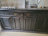 a black cabinet with a mirror on top of it