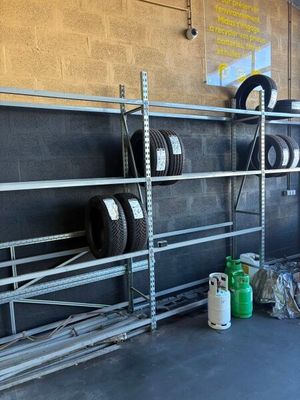 a rack with tires and other items in a garage
