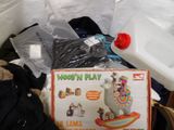 a box of toys and a stuffed animal in a pile