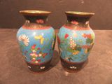 two vases that are sitting on a table