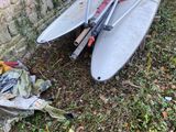a surfboard that is laying on the ground next to a brick wall