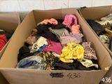 a cardboard box filled with clothes and other items