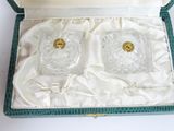 two glasses in a green box on a white table