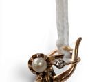 an image of a close up of a piece of jewelry with a flower
