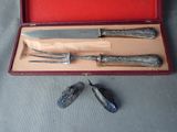 three knives and a knife sharper in a red case