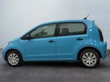 the small blue car is parked in the parking lot
