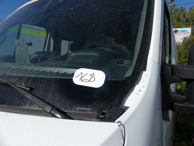 a white van with a sticker on the windshield of it