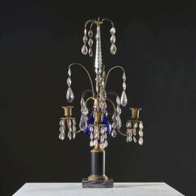 a close up of a blue glass chandelier on a table