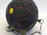 a ball with a chain around it that has a face on it