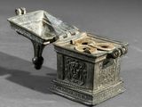 a small silver box with a dog bone inside of it