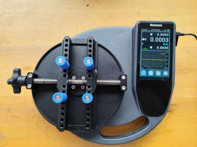 a device that is sitting on a table next to a cell phone