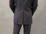 an image of a man in a suit standing in front of a wall