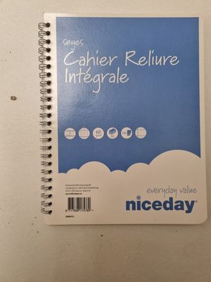 a close up of a spiral notebook on a white surface