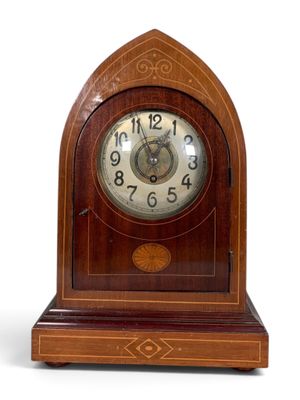 a wooden clock that is sitting on a white surface