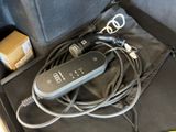 a remote control sitting in a case with a cord