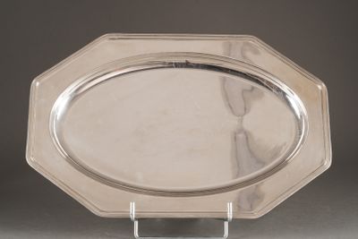 a silver plate on a stand on a table