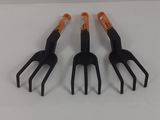 three forks with orange handles sitting on a white surface