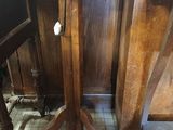 a wooden table with two chairs in the corner of the room
