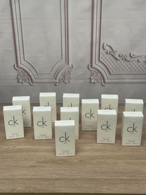 several boxes of ckk perfume sitting on a table in front of a wall