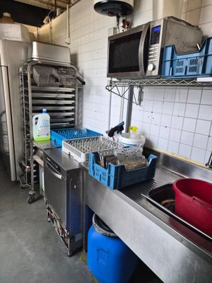 a kitchen with a sink, microwave, and other appliances
