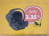 a baby car seat on the side of a yellow box