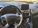 the interior of a car with a steering wheel and a phone on the dashboard