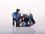 a figurine of two people sitting on a bench