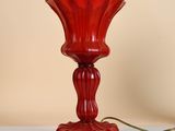 a red lamp that is sitting on a white table