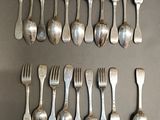 a lot of forks and spoons that are on the table