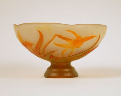a glass bowl with orange and white designs on it