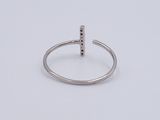 a close up of a silver ring with a bar on it