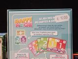a sign that says happy hour on it next to a box of cards