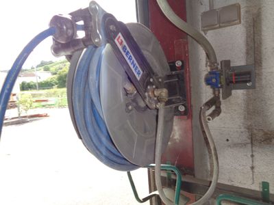a hose attached to the side of a truck with a hose attached to the side of the truck