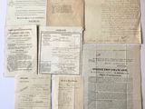 some old papers are laying on top of each other on a table