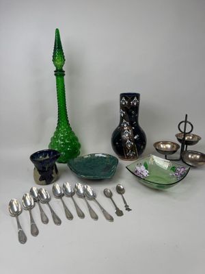 a lot of silver spoons and silverware on the table