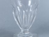 clear glass vase sitting on top of a table on a gray surface