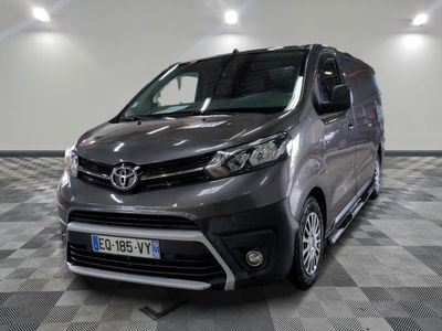 the grey van is parked on a checkered floor in the garage