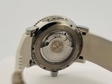 the back of a watch on a white surface with a white background
