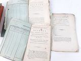 several old books sitting on top of each other on a table