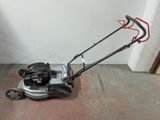 a lawn mower that is sitting on the ground