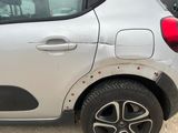 a small white car with holes on the side of it