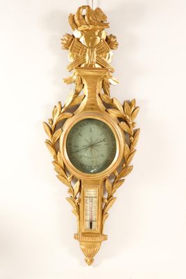 a gold clock on the wall with a bird on it