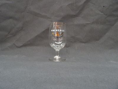a wine glass that is sitting on a table