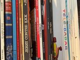 many books that are in a box on the ground