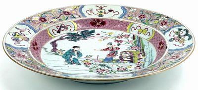 a bowl that has a picture of people in a garden on it