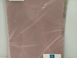 a pink sheet of paper on a white surface