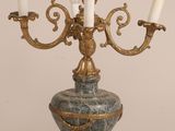 an image of a blue and gold candelier with three candles